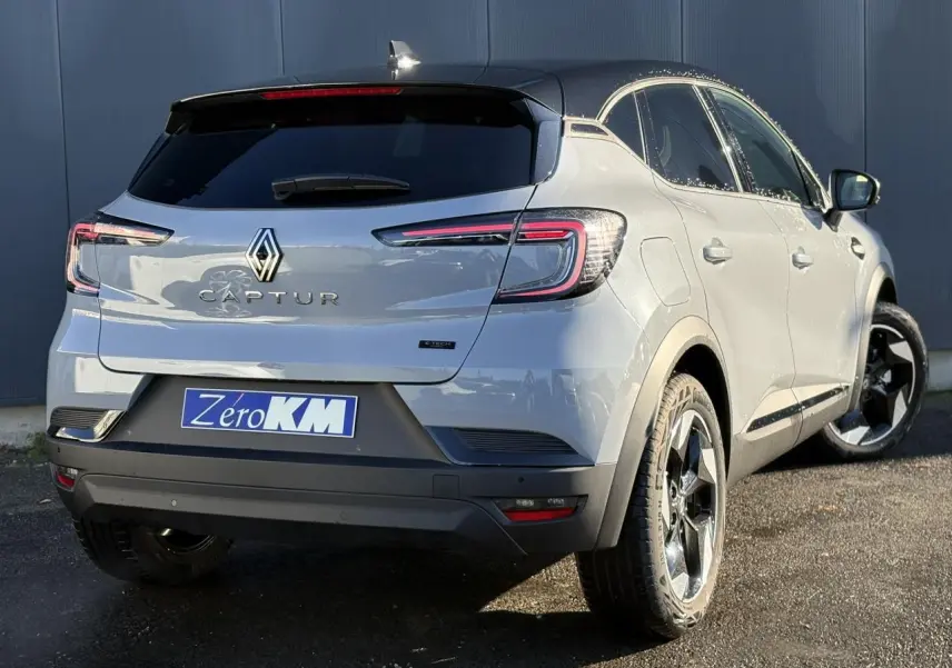 Vue 3/4 arrière droite du Renault Captur gris Rafale et noir avec jantes aluminium 18 pouces et logo E-Tech.