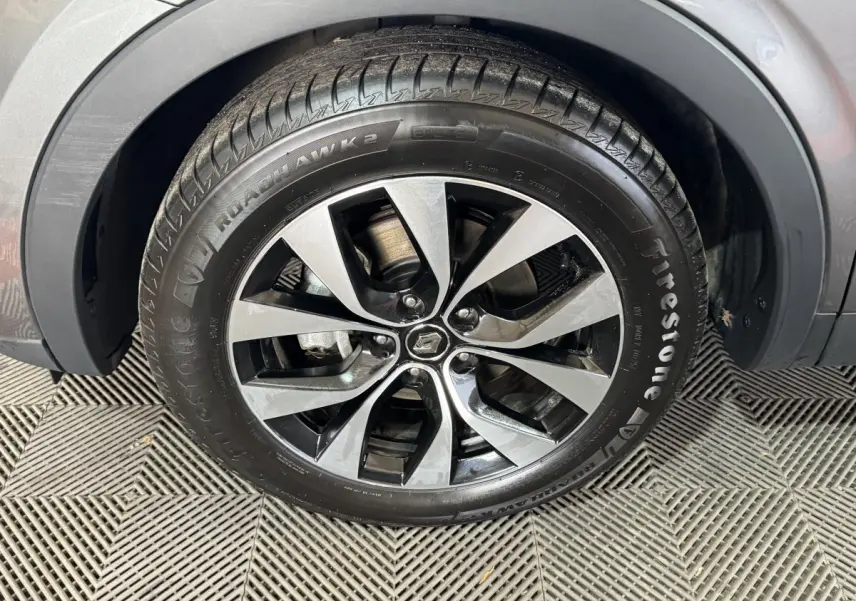 Gros plan sur la roue avant droite avec jante alliage bicolore du Renault Arkana gris foncé Business E-TECH 145.