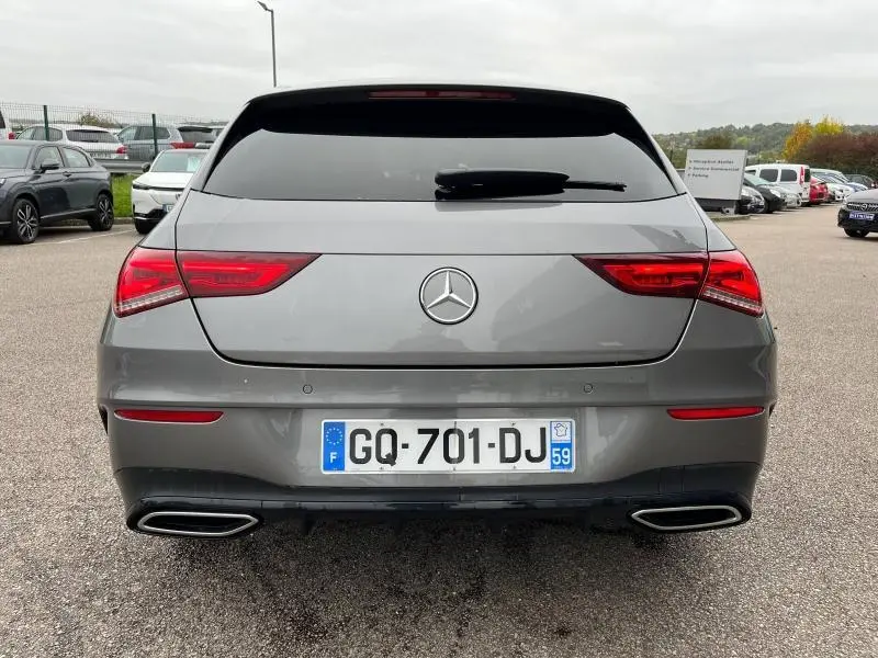 Vue arrière d'une Mercedes Classe CLA Shooting Brake 250 AMG Line 4Matic gris montagne métallisé avec feux LED et double sortie d'échappement chromée.