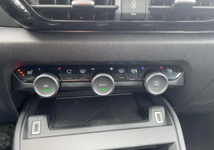 Panneau de commande de climatisation automatique bi-zone de la Citroën C4 hybride 2025, vue frontale intérieure.