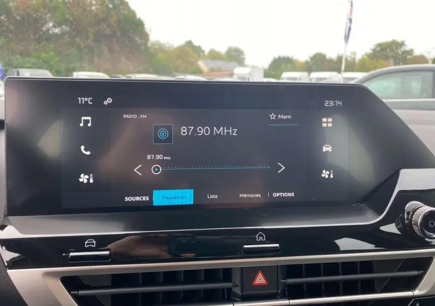 Écran tactile central affichant la radio FM dans l'habitacle moderne d'une Citroën C4 hybride 2025.