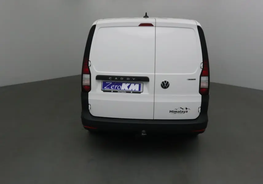 Vue arrière d'un Volkswagen Caddy Maxi blanc version Himalaya avec logo et attelage visible