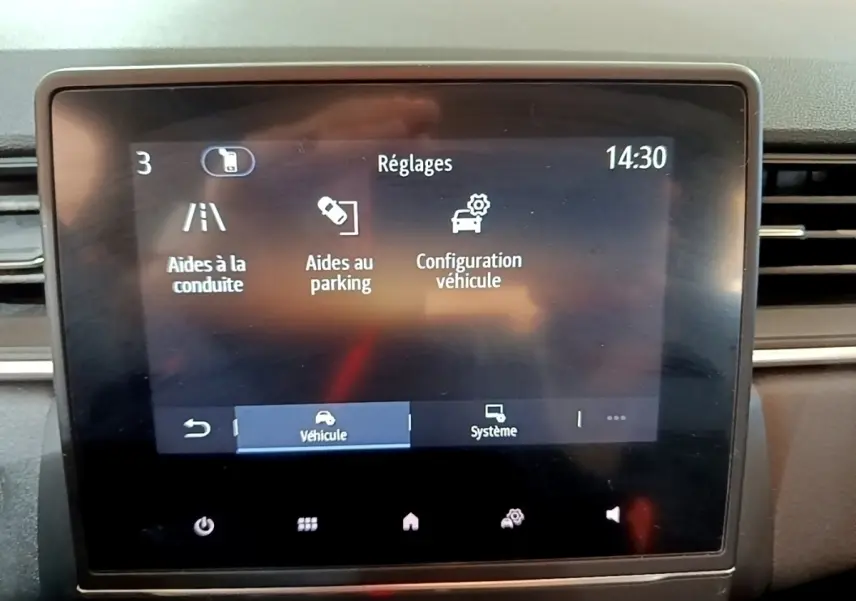 Écran tactile central du tableau de bord du Renault Captur Business 2021 affichant les réglages d’aides à la conduite et au parking.