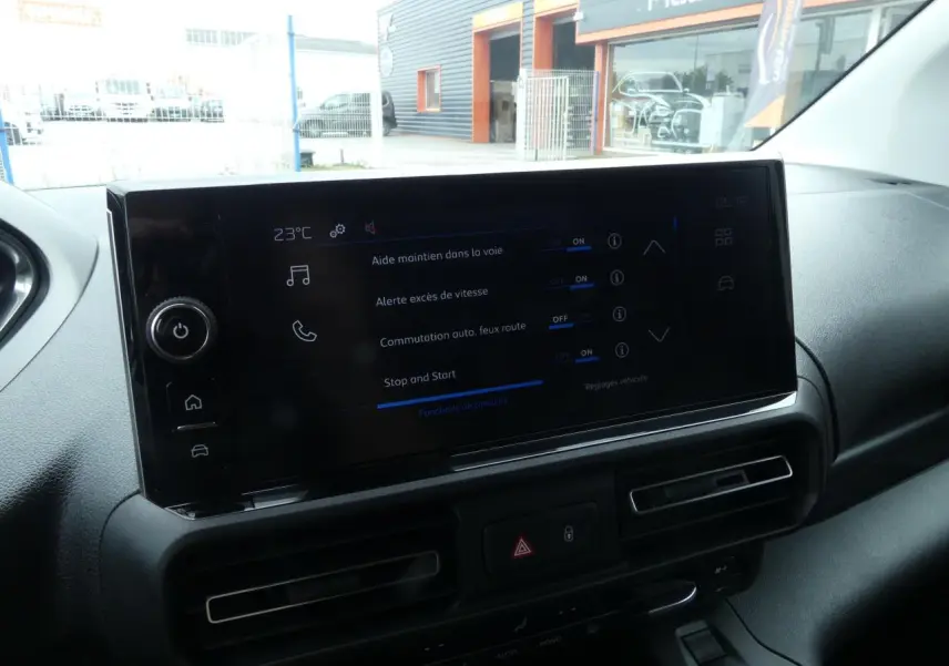 Écran tactile central du tableau de bord du Peugeot Partner blanc, vue intérieure avant droite.