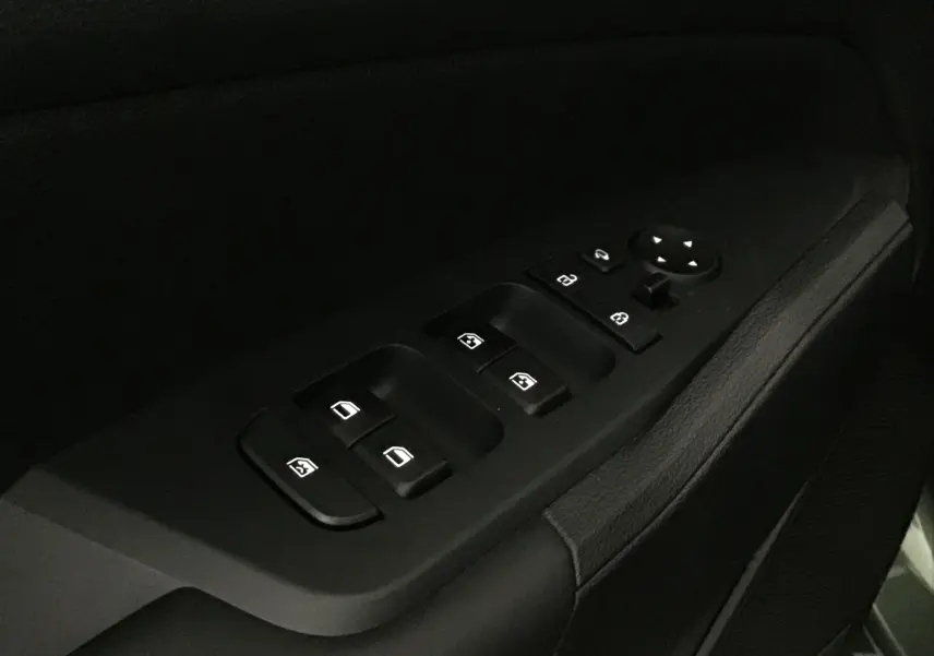 Commandes des vitres électriques et rétroviseurs sur la porte côté conducteur d'un Kia Sportage gris Sirius 2025.