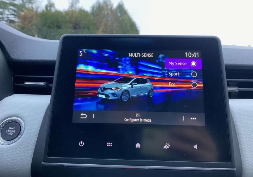 Écran tactile central affichant les modes de conduite avec illustration d'une Renault Clio blanche en 3/4 avant.