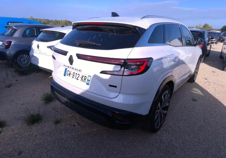 Vue 3/4 arrière droite d'un Renault Austral blanc nacré avec feux arrière LED et toit noir panoramique.