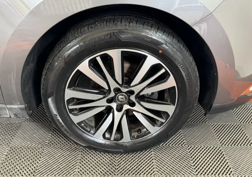 Gros plan sur la roue avant droite du Renault Espace gris foncé, mettant en valeur la jante alliage au design moderne.