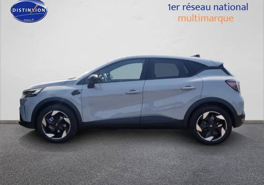 Profil côté gauche du Renault Captur gris rafale 2025 avec jantes alliage et détails noirs contrastants.