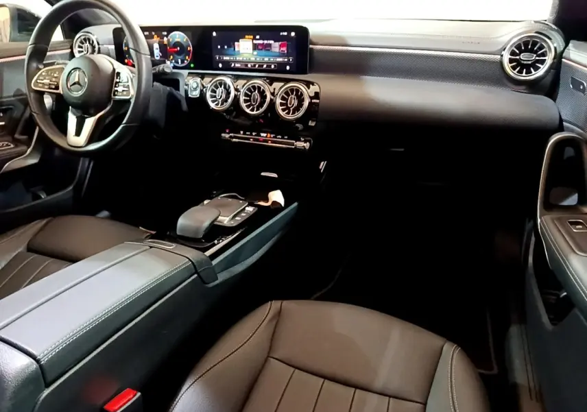Intérieur noir de la Mercedes Classe A 200 d 2022, vue côté conducteur montrant volant cuir et tableau de bord digital.
