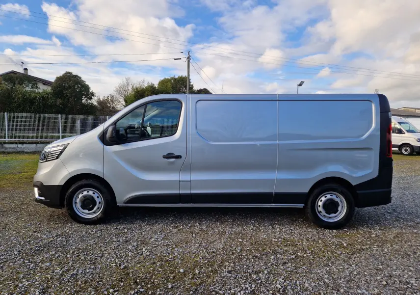Vue de profil côté gauche du Renault Trafic Fourgon gris Highland 2025 avec porte coulissante et jantes acier.