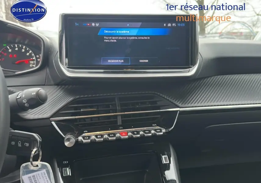 Tableau de bord de Peugeot 208 1.2 100 style 2025, écran tactile central et commandes piano en finition noire.