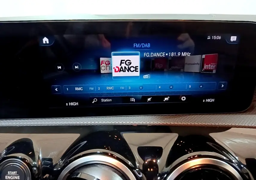 Vue rapprochée de l’écran tactile multimédia et des aérateurs ronds noirs du tableau de bord d’une Mercedes CLA 200 d blanche.