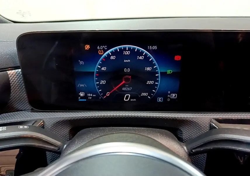 Tableau de bord numérique de Mercedes CLA 200 d Business Line 2021, affichage vitesse et alertes, vue frontale rapprochée.