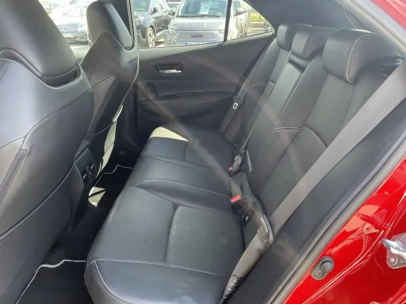 Vue intérieure côté droit des sièges arrière noirs en cuir de la Toyota Corolla 184 H Collection rouge métal de 2019.