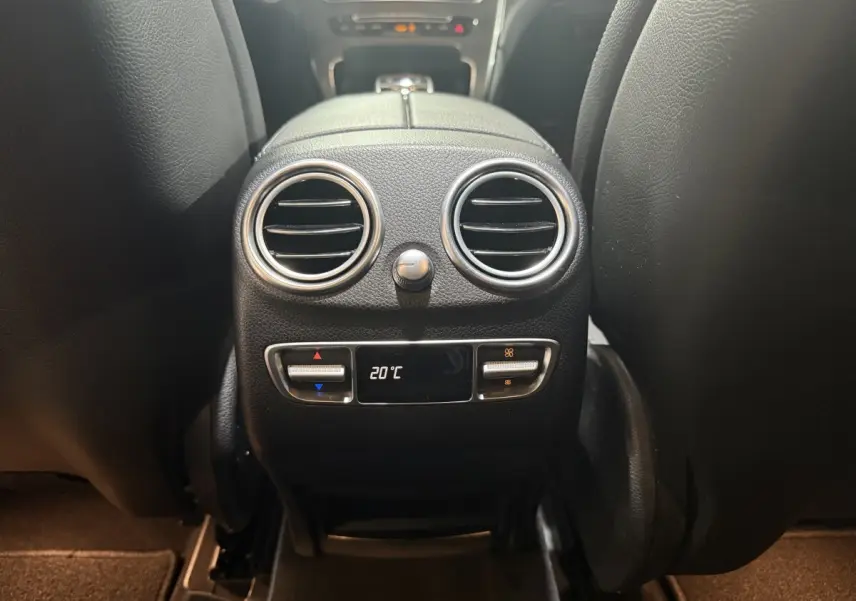 Vue rapprochée de la console centrale arrière noire du Mercedes GLC 250 Fascination 2019 avec réglage climatisation à 20°C.