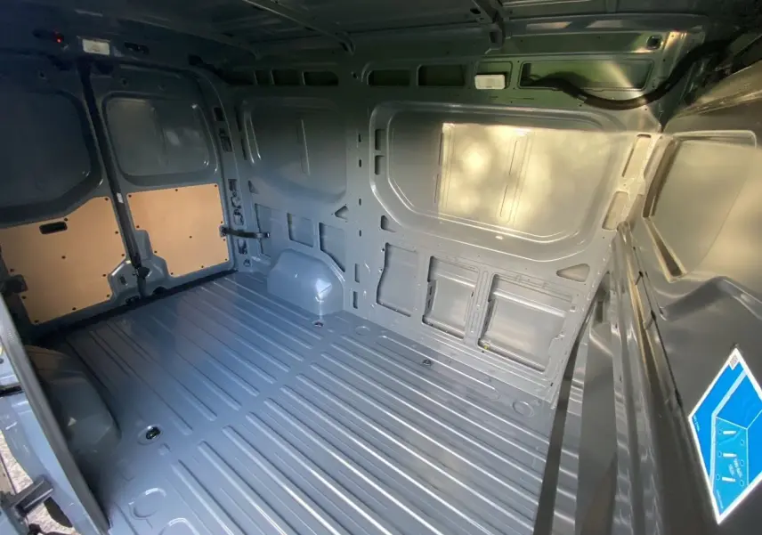 Vue intérieure arrière du Renault Master 2025 gris urbain, montrant l’espace de chargement tôlé et le plancher métallique.