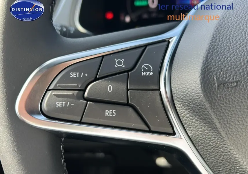 Gros plan sur les commandes multifonctions à gauche du volant cuir du Renault Captur noir étoile 2025 hybride.