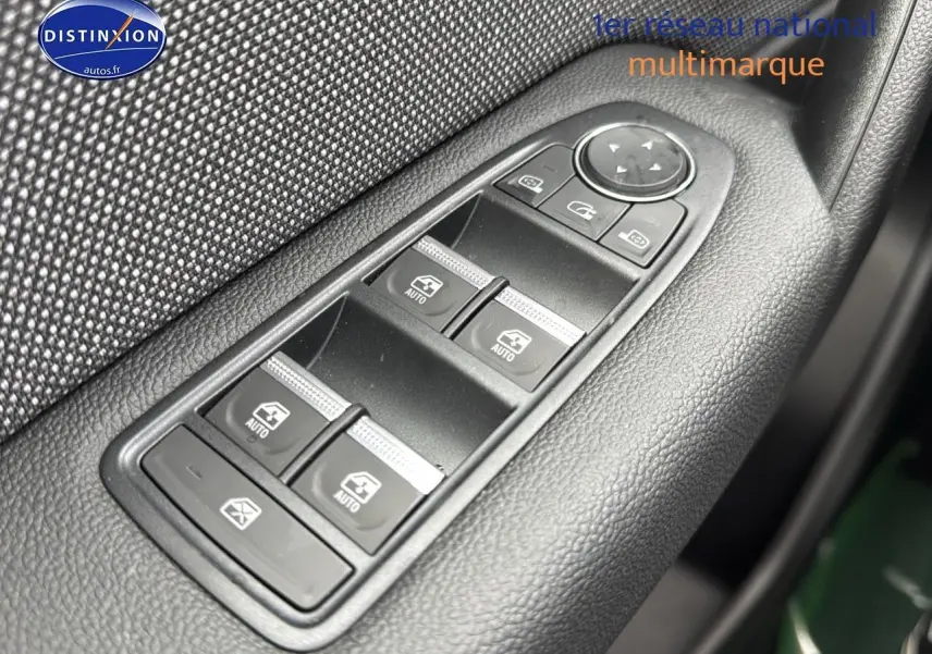 Gros plan sur les commandes des vitres électriques côté conducteur du Renault Captur gris cassiopée 2025.