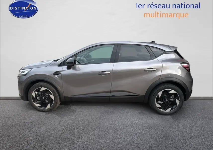 Profil droit du Renault Captur gris cassiopée 2025 avec jantes alu noires et détails noirs contrastants.