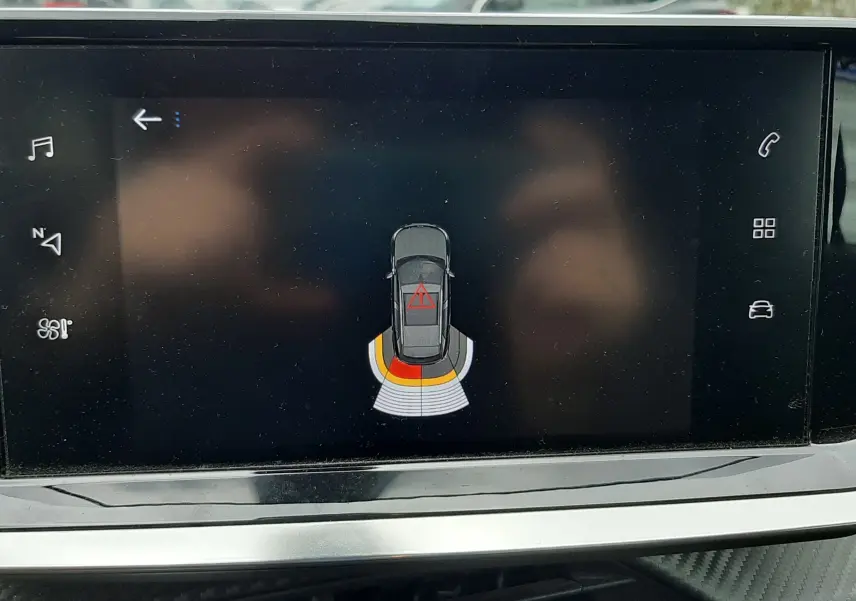Écran de la Peugeot 2008 1.5 BlueHDi 2020 montrant l'alerte de proximité arrière avec signalisation en rouge et orange.