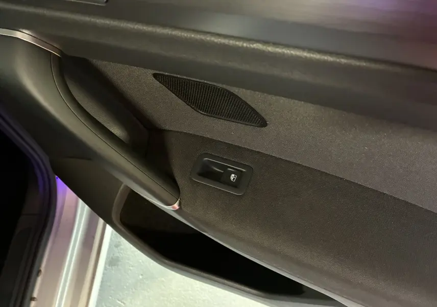 Détail de la porte intérieure côté gauche en tissu gris noir avec commande de vitre électrique sur Volkswagen Golf Sportsvan 2019.