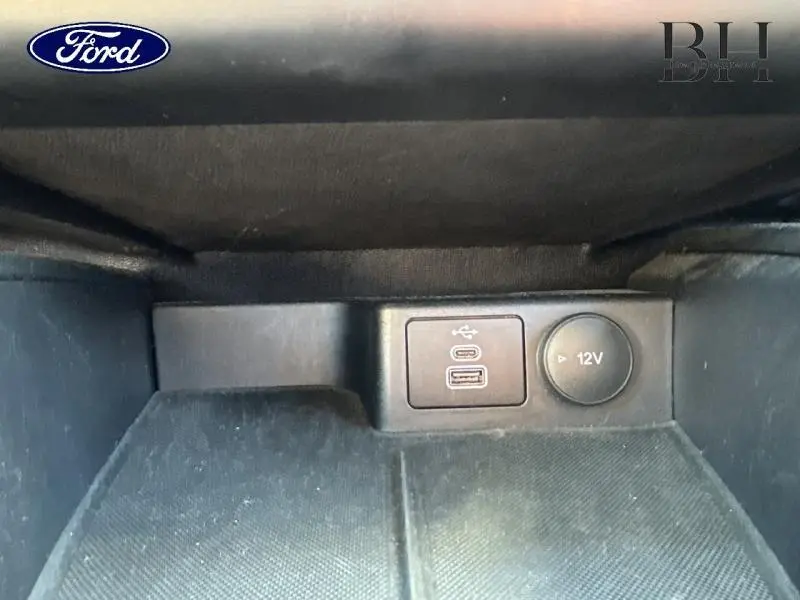 Prise USB et prise 12V dans l'accoudoir central avant du Ford Kuga gris métallisé 2022 Titanium.