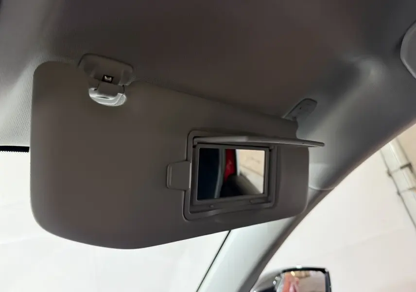 Miroir de courtoisie ouvert sur pare-soleil côté conducteur dans Peugeot 308 rouge vue intérieure avant gauche.