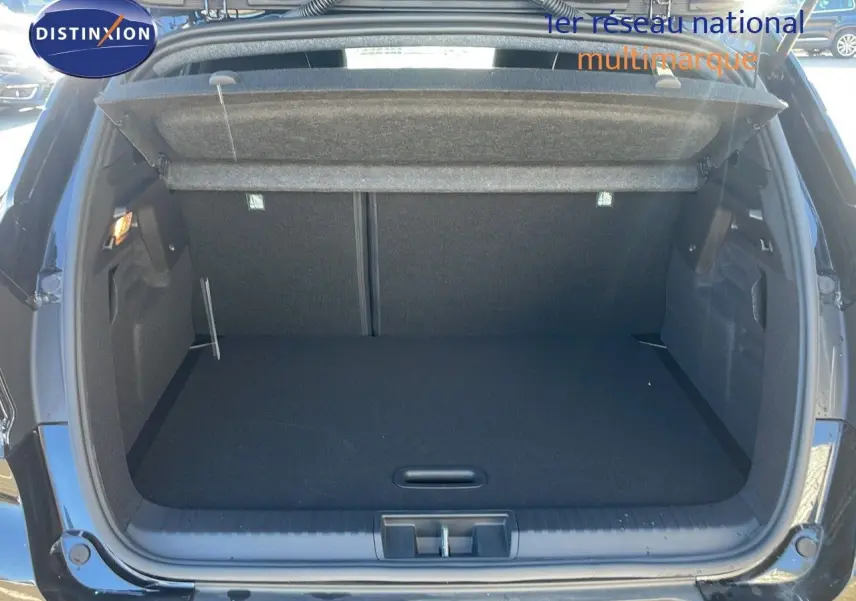 Coffre ouvert vu de l'arrière d'un Renault Captur noir étoile métal, montrant un espace de rangement vide et propre.