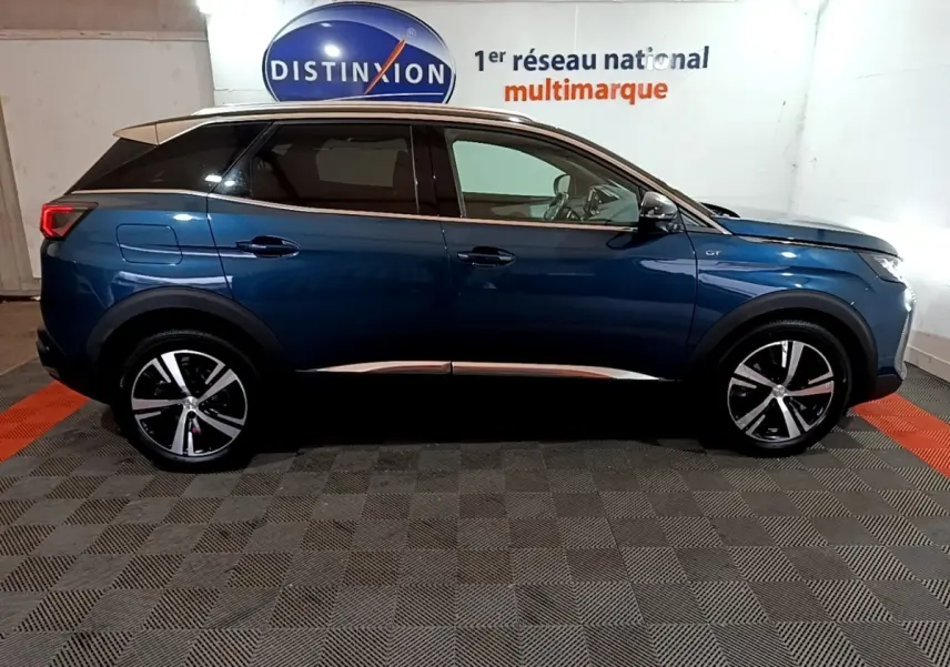 Vue latérale droite d’un Peugeot 3008 bleu 2021 GT avec toit noir et jantes alliage bicolores.