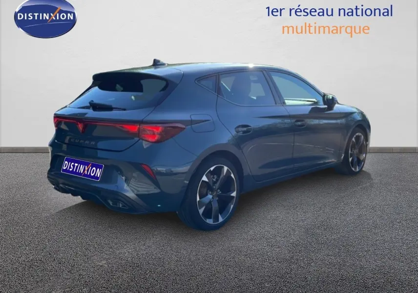 Vue 3/4 arrière droite d'une CUPRA Leon 1.5 eTSI 150CH DSG bleu fjord avec jantes bi-ton et feux LED distinctifs.