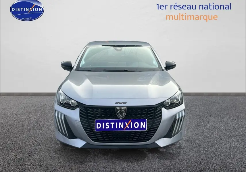 Vue frontale d'une Peugeot 208 1.2 100 style gris artense avec calandre noire et phares LED distinctifs.