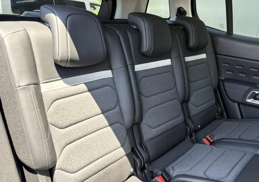 Vue intérieure des trois sièges arrière indépendants en tissu gris et noir du Citroën C5 Aircross Hybrid 2025.