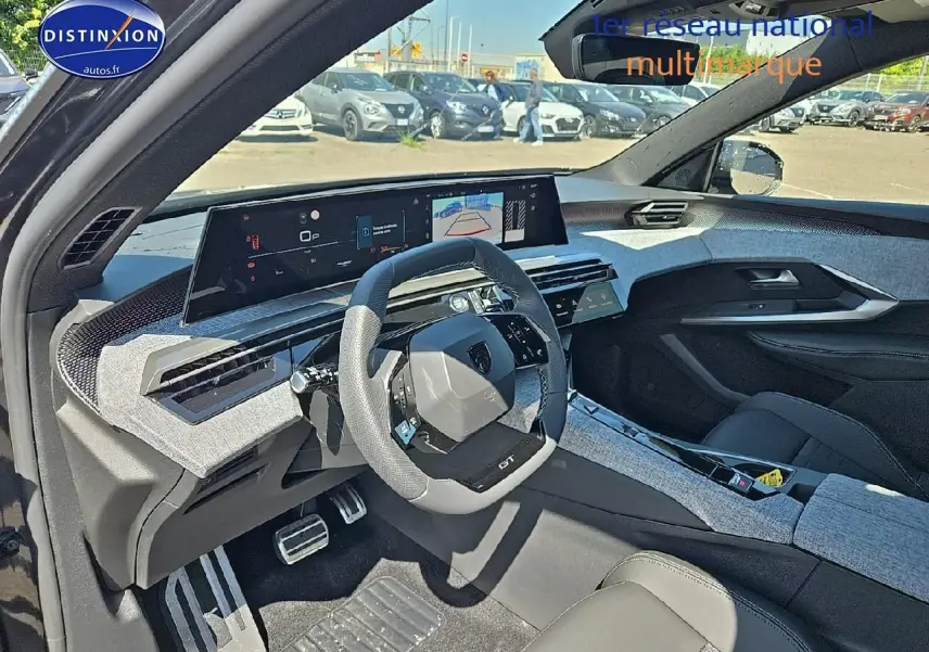 Intérieur du Peugeot 5008 Hybrid gris titane, vue côté conducteur, volant compact et tableau de bord numérique large.