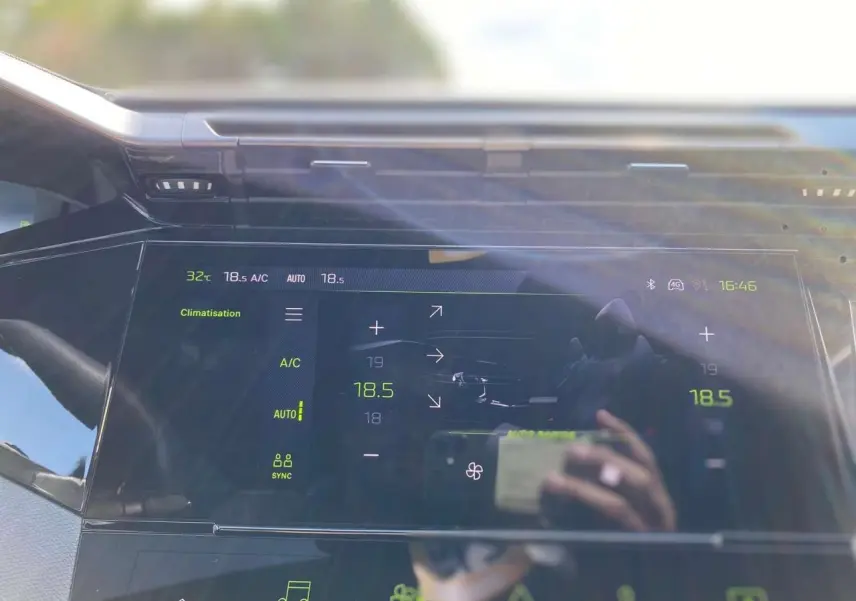 Écran tactile central de la Peugeot 308 GT 2025 montrant les réglages de climatisation à 18,5°C en intérieur.