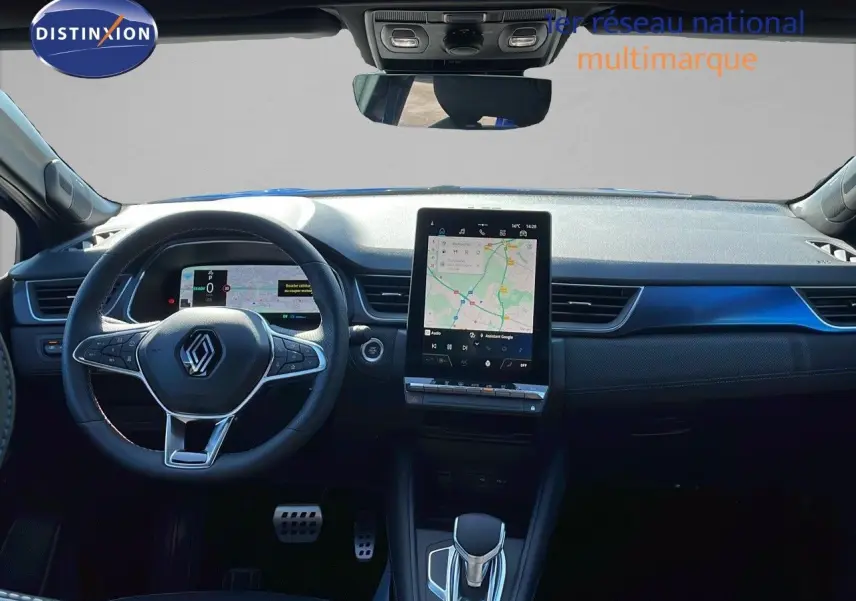 Vue intérieure frontale du tableau de bord du Renault Captur E-Tech hybride 2025 avec écran tactile et volant noir.