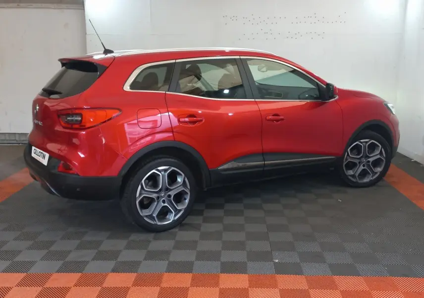 Renault Kadjar Intens rouge vue de profil côté gauche, avec jantes distinctives et protections noires basses.