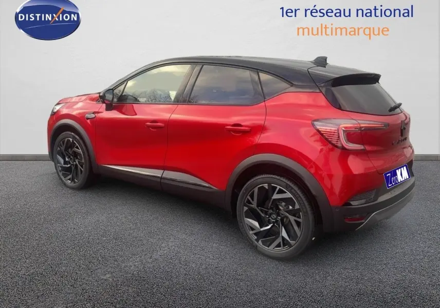 Vue 3/4 arrière droite du Renault Captur E-Tech hybride rouge passion avec toit noir et jantes noires distinctives.