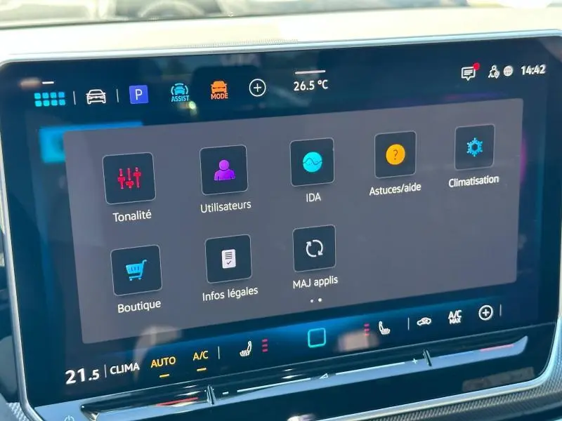 Écran tactile central de la Volkswagen Golf 2025 noir, affichant le menu des réglages et la climatisation en intérieur.
