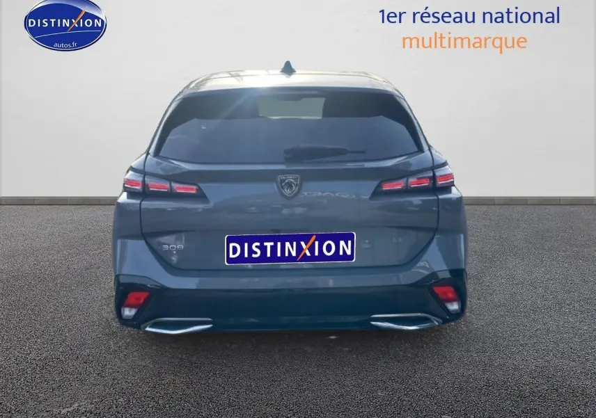 Vue arrière d’une Peugeot 308 SW gris sélénite avec feux LED et double sortie d’échappement chromée.