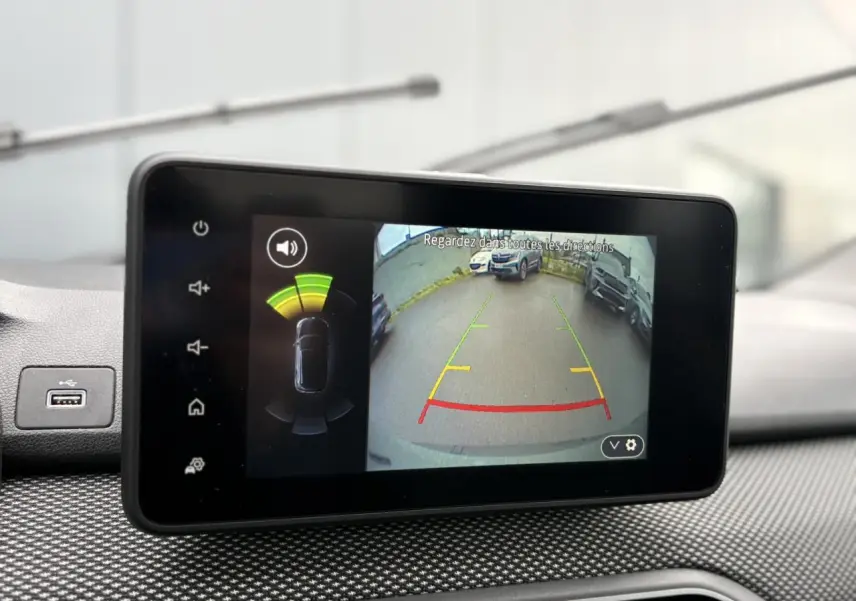 Écran tactile intérieur montrant la caméra de recul et l’aide au stationnement du Dacia Jogger Kaki Lichen.