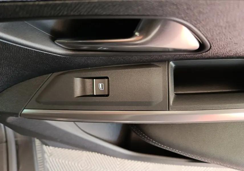 Détail de la commande de lève-vitre côté conducteur du Peugeot 3008 1.2 Hybrid 145 GT, intérieur noir.