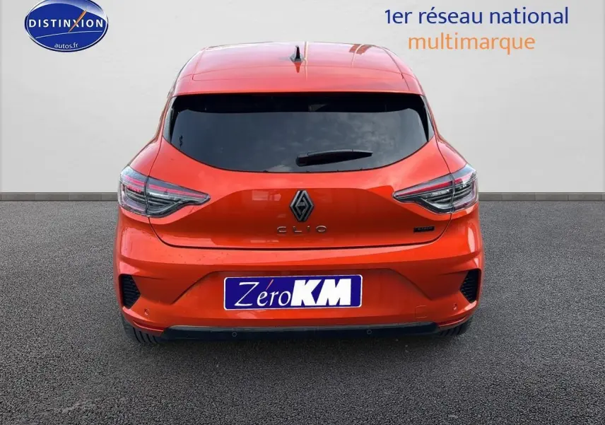 Vue arrière d'une Renault Clio V orange Valencia avec feux LED et logo central sur fond neutre.