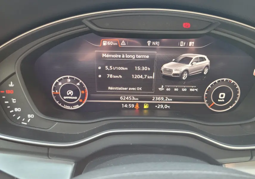 Tableau de bord numérique de l'Audi Q5 noire 2018 affichant consommation, vitesse moyenne et image du véhicule en 3D.