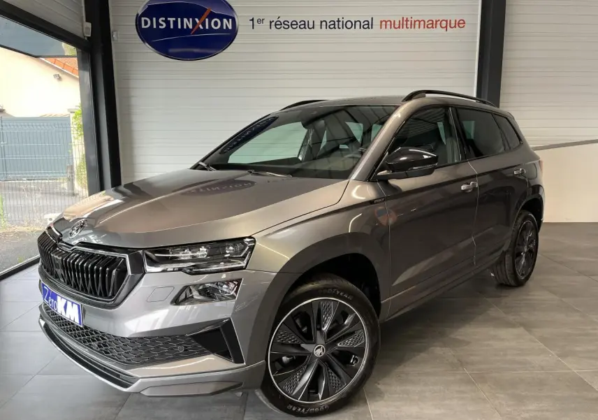 SKODA KAROQ gris perle en 3/4 avant droit avec jantes alliage 19'' Sagitarius anthracite et calandre noire sportive.