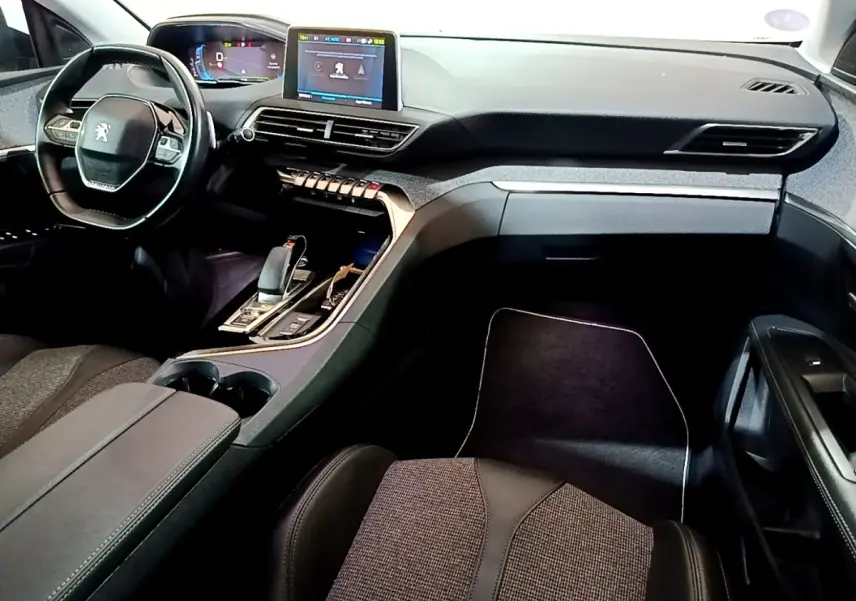 Vue intérieure avant droite du Peugeot 3008 blanc, mettant en valeur le tableau de bord digital et la console centrale moderne.