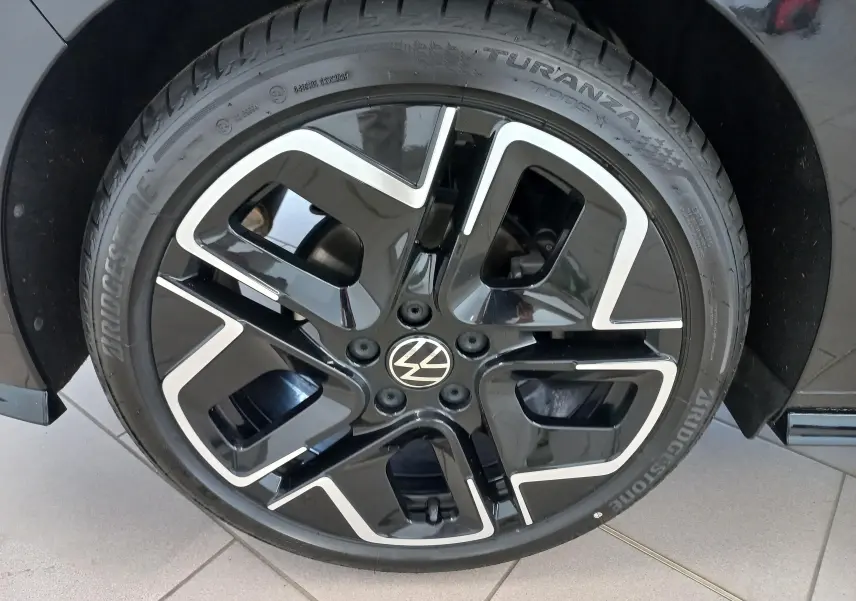 Gros plan sur la jante noire et argentée d'une Volkswagen Golf 1.5 eTSI 150 DSG7 R-Line Edition noir ébène.