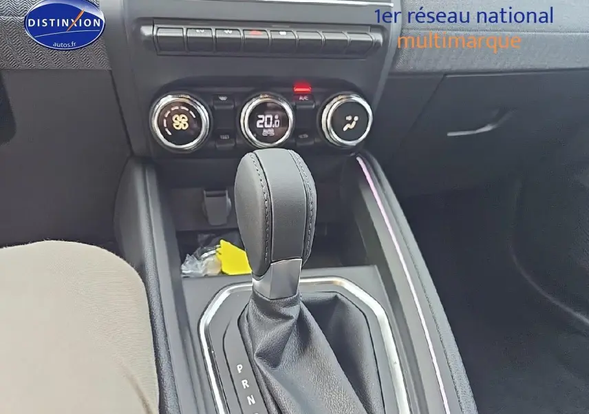 Le levier de boîte automatique de la Renault Clio V gris schiste, avec commandes de climatisation et éclairage d'ambiance violet.