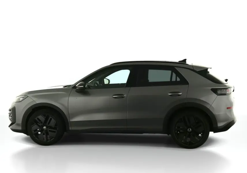 Vue de profil côté gauche du Volkswagen T-Roc 2026 gris Loup avec jantes noires sport et toit noir.