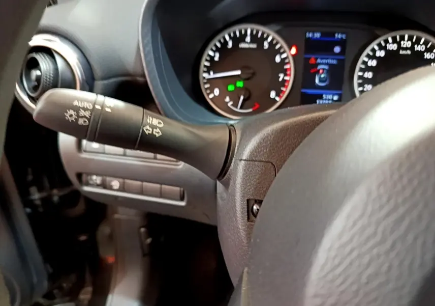 Gros plan sur le volant et le combiné d'instruments du Nissan Juke noir, avec affichage digital et commandes au volant visibles.